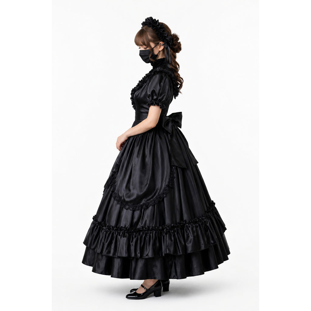 Elegant black sissy maid dress with ruffles, bow, and layered skirt, styled with matching headpiece and heels.