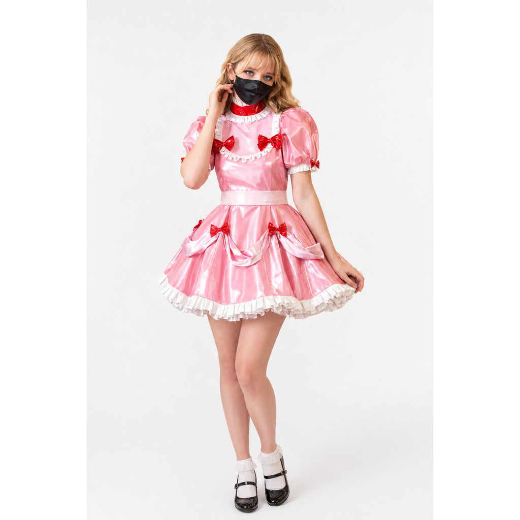 Pink sissy maid dress with red bows, white ruffles, and PVC finish, styled with black mask and Mary Jane shoes