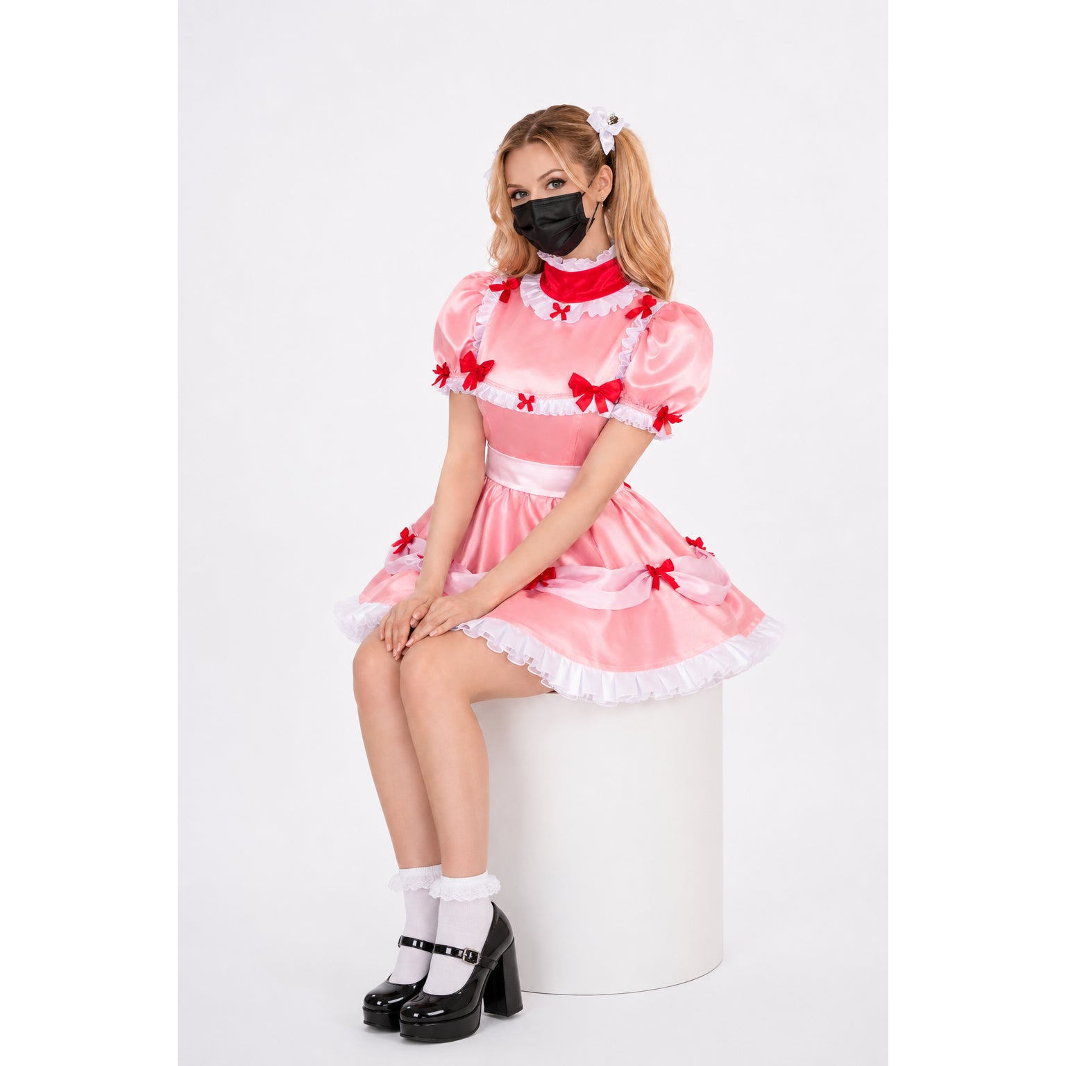 Pink sissy maid dress with red bows, white ruffles, and satin finish, styled with black heels and mask