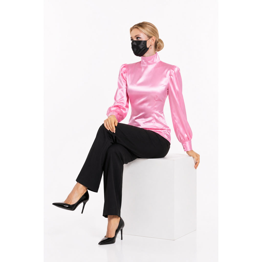 Pink satin blouse with puffed sleeves, black pants, and heels — sissy maid dress style