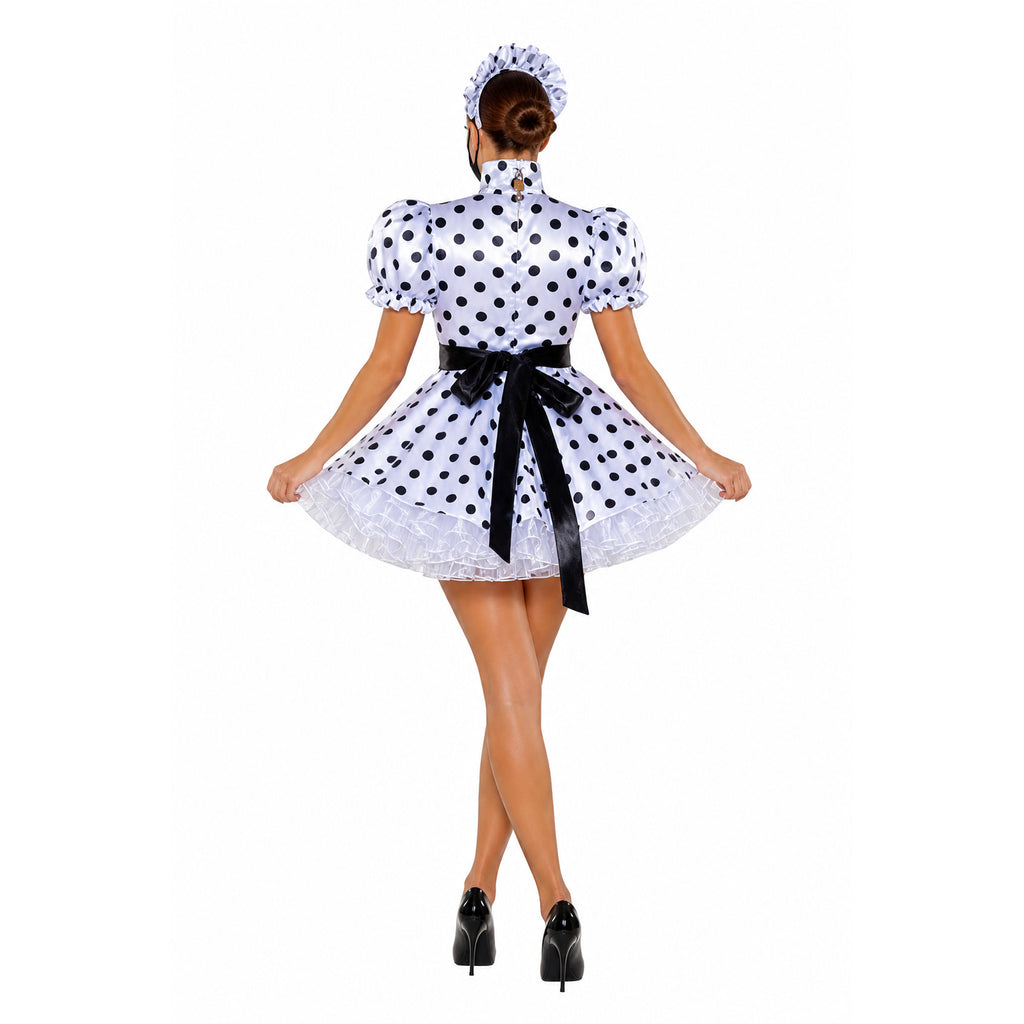 Polka dot sissy maid dress with black bow, ruffled hem, and matching headpiece, worn with high heels.