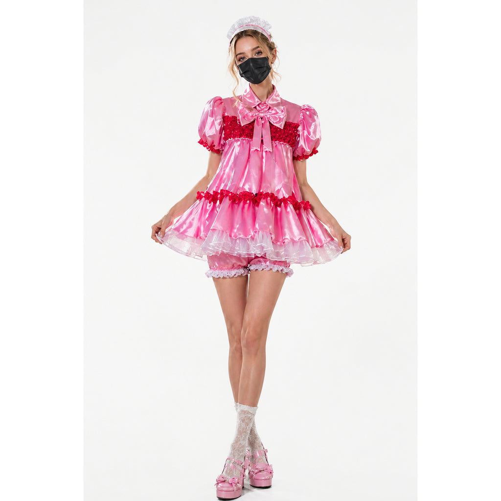 Pink sissy maid dress with red ruffles, satin bow, and matching panties, styled with lace socks and platform heels
