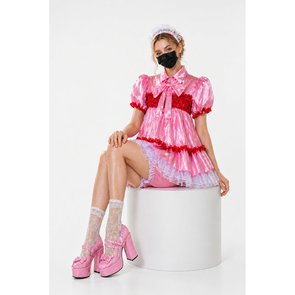 Pink sissy maid dress with red ruffles, lace socks, and platform heels, styled with a matching headband.