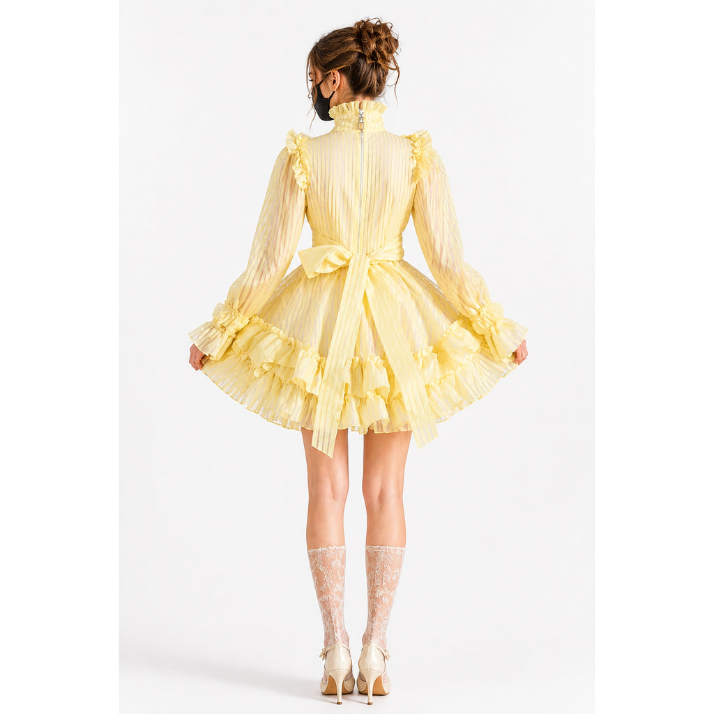 Yellow sissy maid dress with ruffles, bow, and sheer sleeves, shown from back with lace stockings