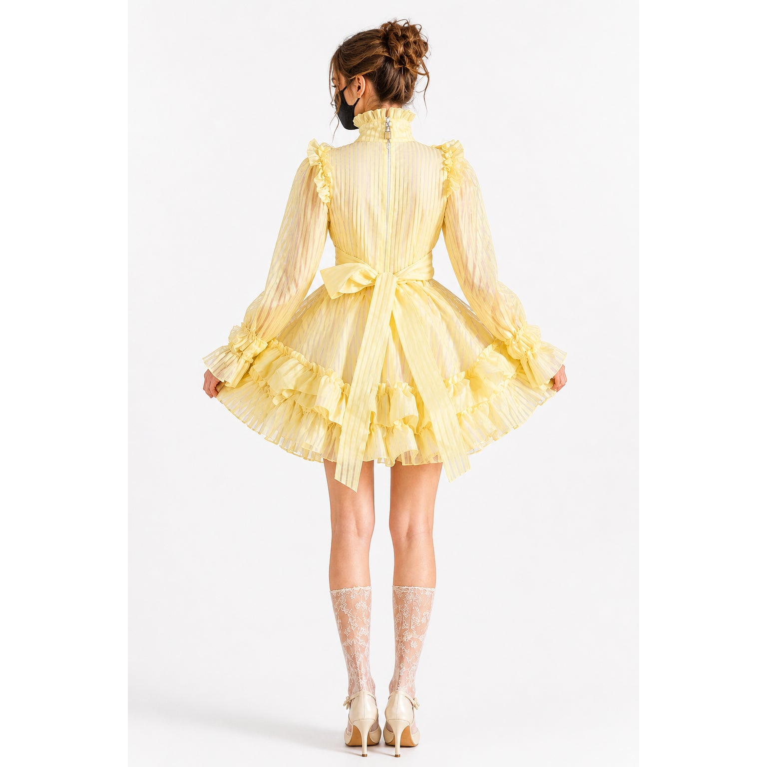 Yellow sissy maid dress with ruffles, bow, and sheer sleeves, shown from back with lace stockings