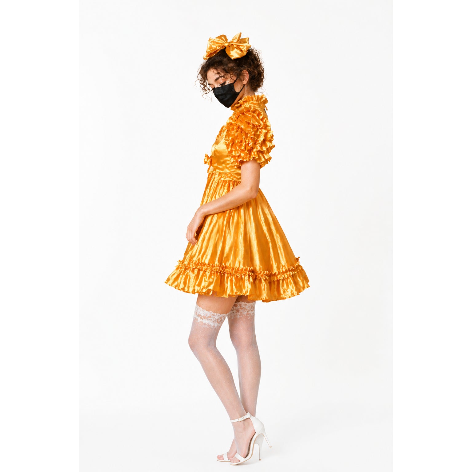 Golden sissy maid dress with ruffles, matching bow, lace stockings, and white heels
