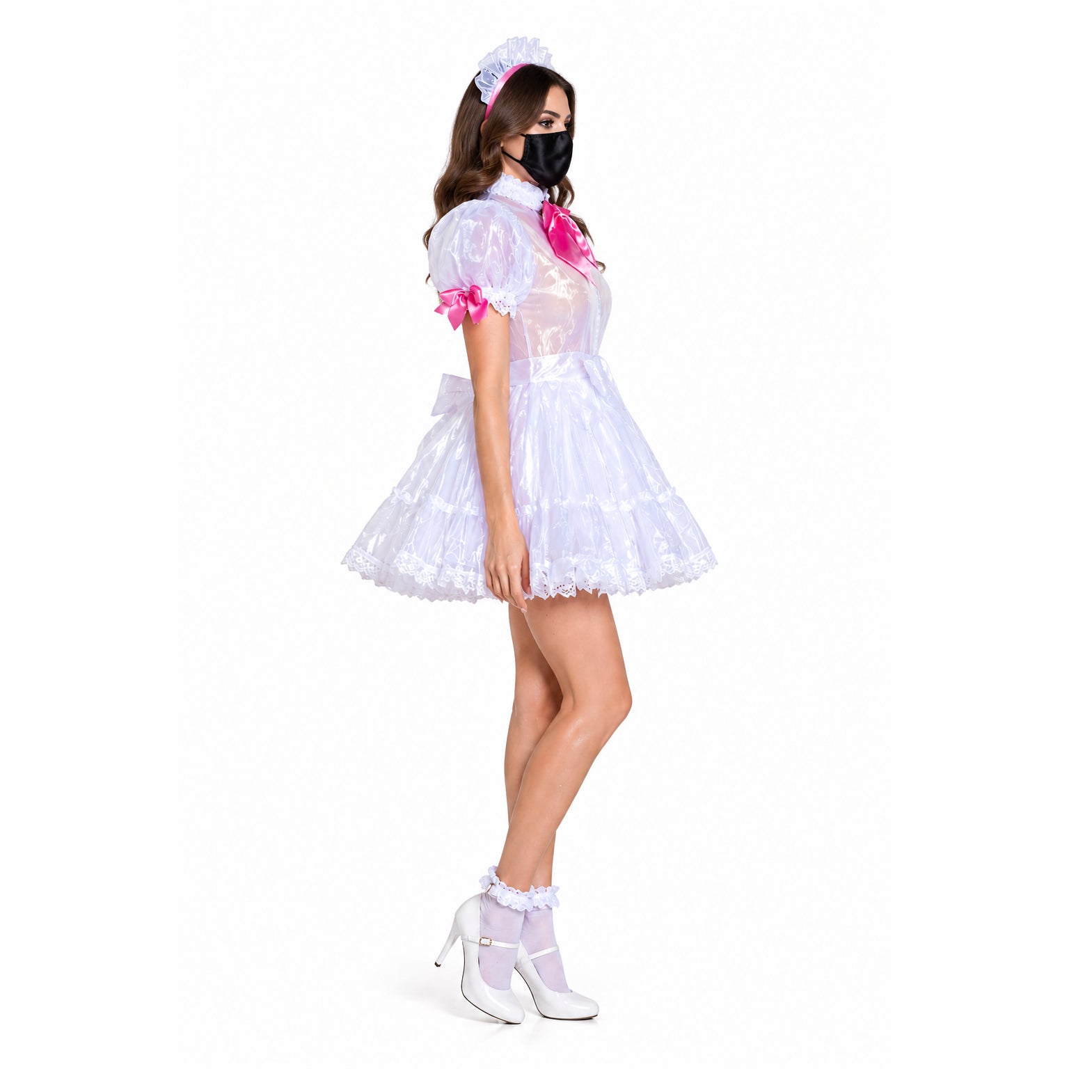 White sissy maid dress with pink bows, lace trim, and matching headband, styled with heels and stockings.
