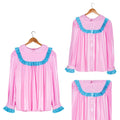 Pink PVC sissy maid dress with blue ruffles, button front, and pleated design on hanger